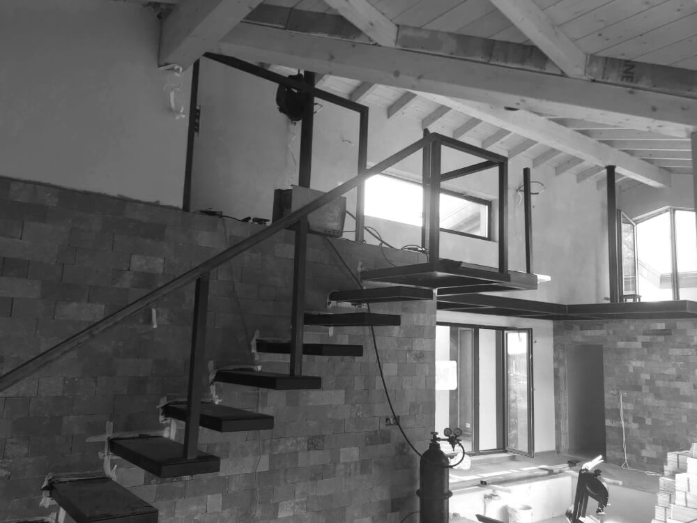 Частично изградено плаващо стълбище от Интериорен дизайн Studio28a в модерен интериор в процес на обновяване.